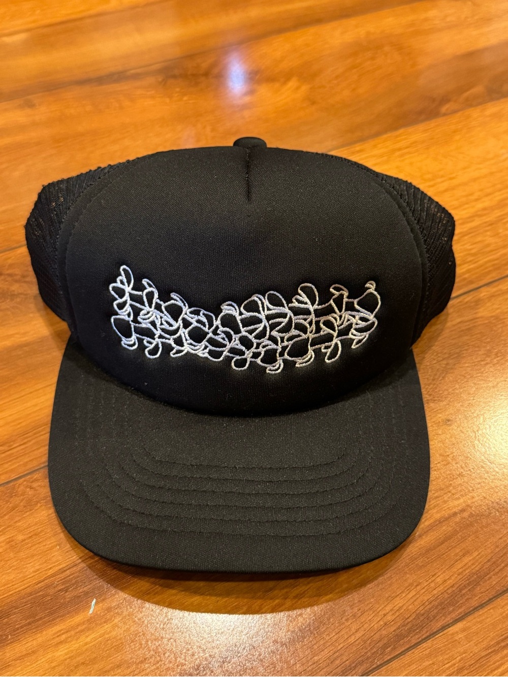 Black Trucker Hat with White Puakenikeni Flowers